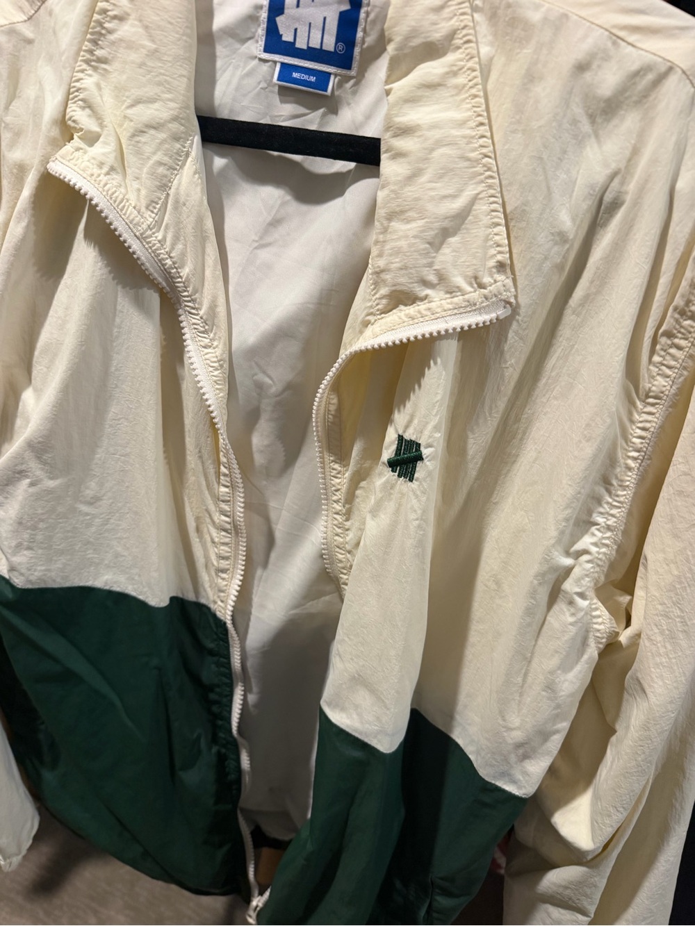 Undefeated Cream Jacket with Blue Logo Patch